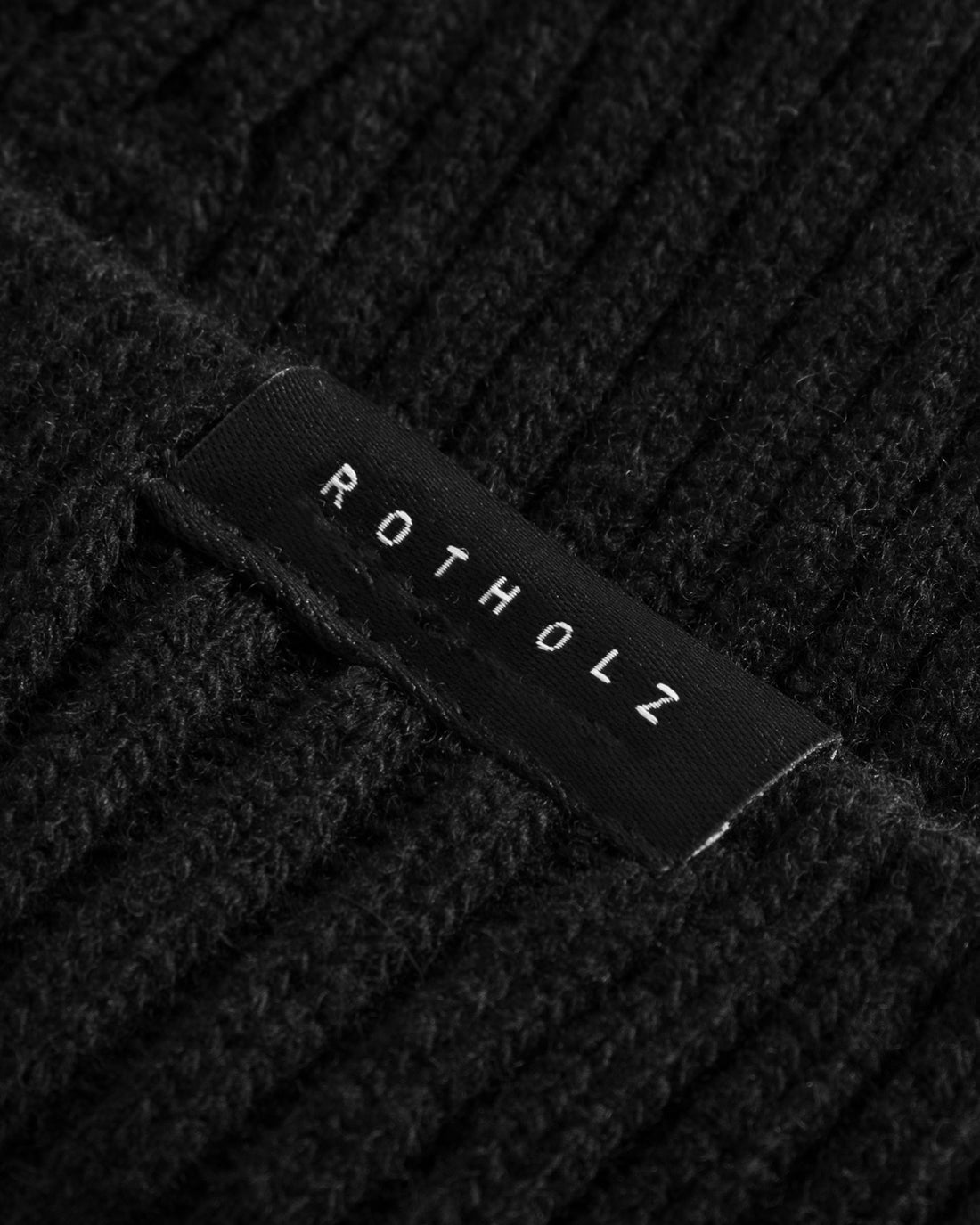 Black short hat made of wool mix rib by Rotholz