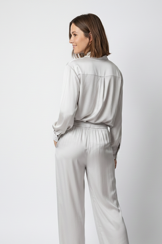 Woman wearing a light gray outfit on a white background