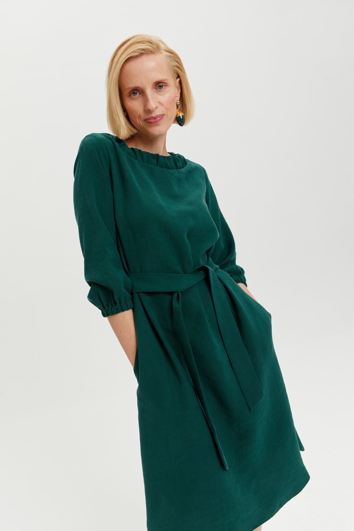 Celine | Elegant belted dress with décolleté element in forest green by Ayani